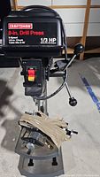 Craftsman drill press head showing brand, speed, chuck size, and horse power specification.