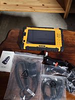 Yellow RFinder tablet and accessories on wooden table