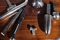 Overall view of seven forming stakes on wooden surface