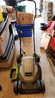 Side view of Lawn Master electric lawn mower showing handle, wheels, and body with attached cord.