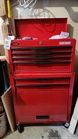 Front view of closed red Craftsman tool chest on wheels