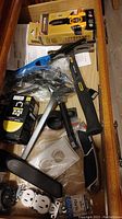 Drawer overview showing various tools including measuring tape, hose nozzle, lighter, electrical covers, and other tools