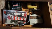 Drawer with assorted tools including boxed Craftsman 2pc ratchet multi-grip pliers set and yellow power inverter with attached cables