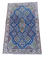 Full top-down view of the blue and white Nain rug with geometric and floral patterns