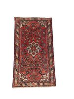 Full view of the rectangular Persian Hamedan wool rug showing central floral medallion and border patterns.