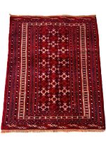 Full view of the rectangular Turkmen rug showing overall design and color scheme.