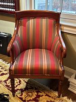 Front view showing striped upholstered seat, curved back and mahogany frame