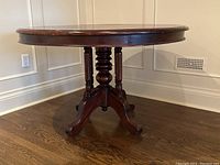 Full view of round table showing turned central column and tripod base