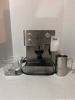 Front view of Saeco Aroma espresso machine with accessories.