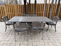 Overhead front view of metal table and six chairs on patio