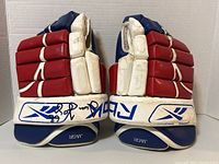 Front view of pair showing red, white and blue color blocking and signature placement