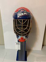 Front view of Labatt Blue goalie helmet beer can dispenser showing front grill and branding.