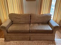 Front view of taupe velvet loveseat showing overall shape and proportions