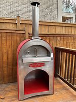 Front view of the stainless steel outdoor pizza oven showing full unit and chimney