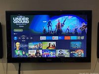 Front view of mounted TV displaying Amazon Fire TV interface.