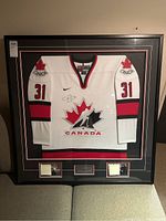 Full view of framed jersey with mats, plaque and photos