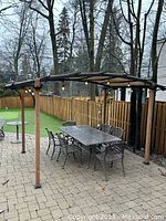Front view showing entire pergola over patio set