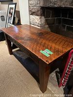 Oblique front view showing full table profile against fireplace backdrop