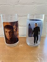 Front view of two glasses featuring Spock's close-up portrait and Captain Kirk standing with a Star Trek background.