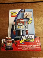 Front of packaging showing the Mega Action Spinning Sparks toy figure in blister pack with Disney Pixar Toy Story branding.