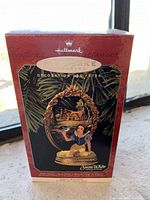 Front photo of the Hallmark Keepsake Christmas ornament box featuring Snow White in an oval frame with cottage background and animals, emphasizing the collectible nature of the figurine.