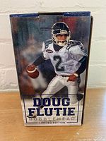 Box front showing the Doug Flutie bobblehead in Toronto Argonauts white football uniform.