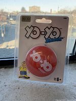Front view of the Yo-Yo Junior toy in sealed original packaging showing red yo-yo and branding.