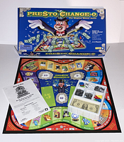 Full display of Presto Chango-O game board laid out with box cover, rule sheet, and plastic tray holding play money and game pieces.