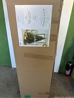 Box of Wondershop Virginia Pine 7.5 ft Unlit Christmas Tree showing the closed packaging with the product label and image of the tree decorated.