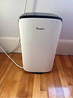 Front view of the Vacplus dehumidifier showing white body with Vacplus logo and black top control area.