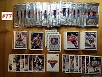 Display of all hockey cards mostly sleeved and related sealed packs laid out.