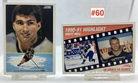 Two hockey cards displayed on stands, Ray Bourque card on left and Brett Hull highlight card on right