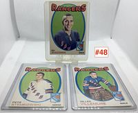 Three hockey cards from 1970-71 featuring New York Rangers players Ed Giacomin, Pete Stemkowski, and Gilles Villemure in protective sleeves with label #48.
