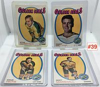 Four California Golden Seals hockey cards shown upright in protective sleeves: Stan Gilbertson, Tommy Williams, Ernie Hicke, and Bert Marshall.
