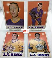 Four L.A. Kings hockey cards from the 1969-1970 season featuring Ross Lonsberry, Eddie Joyal, Denis DeJordy, and Matt Ravlich against an orange background.