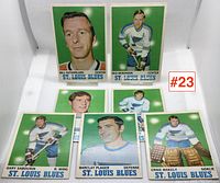 Photo showing seven St. Louis Blues hockey cards from the 1969-1970 season including Bill Sutherland, Red Berenson, Gary Sabourin, Barclay Plager, and Ernie Wakely.