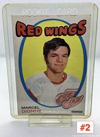 Front view of Marcel Dionne hockey rookie card with portrait, Red Wings logo, and player name under the heading ROOKIE CARD.