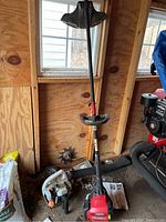 Photo of Troy-Bilt Jumpstart edger, showing the full length with handle and red motor housing