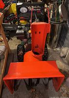 Front view showing auger housing, skid shoes and 24-inch clearing width