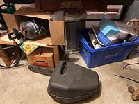 Photo of McCullough chainsaw in plastic carrying case near other miscellaneous items