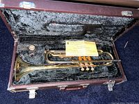 Silver-plated trumpet in black plush-lined rectangular hardshell case with yellow certificate