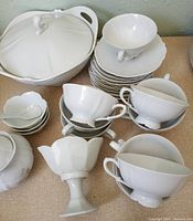 Overview photo showing most items including teacups stacked, small bowls, and covered serving bowl.