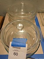 Four clear round Pyrex glass dishes, one large with lid, one small with chipped lid, one large without lid, plus round Jell-O mold.