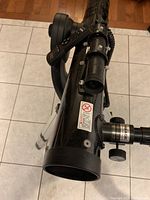 Black telescope tube on mount, showing focuser and front end.