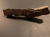 Side view showing thickness and rough dark fusion crust