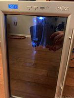 Salton wine/beverage fridge front with glass door and digital temperature display at 58°F.