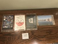Front view of set of four Pink Floyd postcards laid flat in protective sleeves, showing album art.