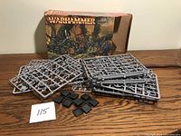 Multiple sprues of unassembled plastic goblin miniatures laid out in front of the box, showing detail of parts and inclusion of square bases.