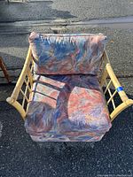 Front view of bamboo chair showing floral cushioned seat and backrest