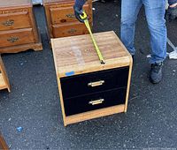 Bedside table shown from side with tape measure indicating depth of approx 22 inches.
